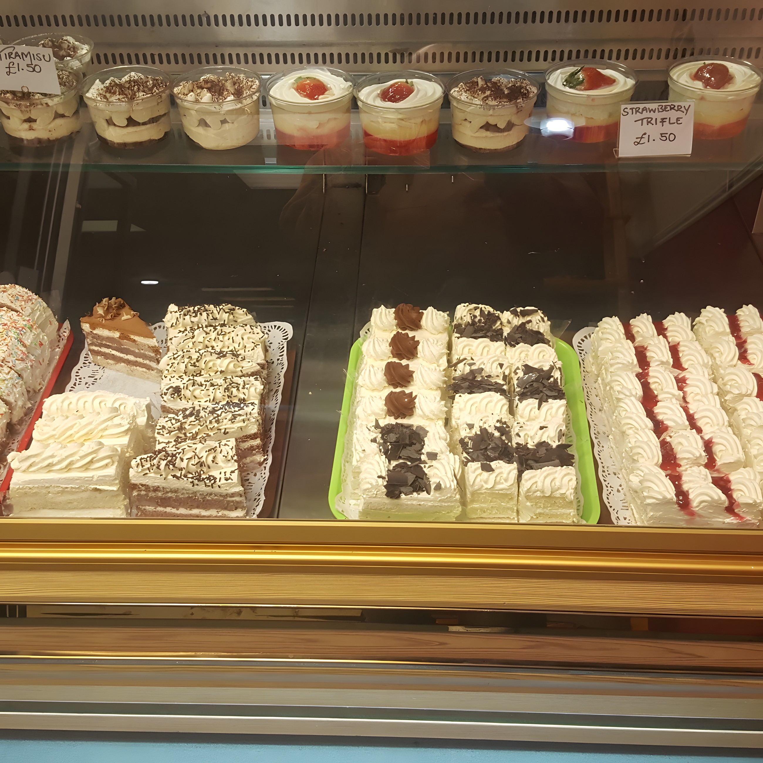 Chilled display of cakes, cream slices and desserts