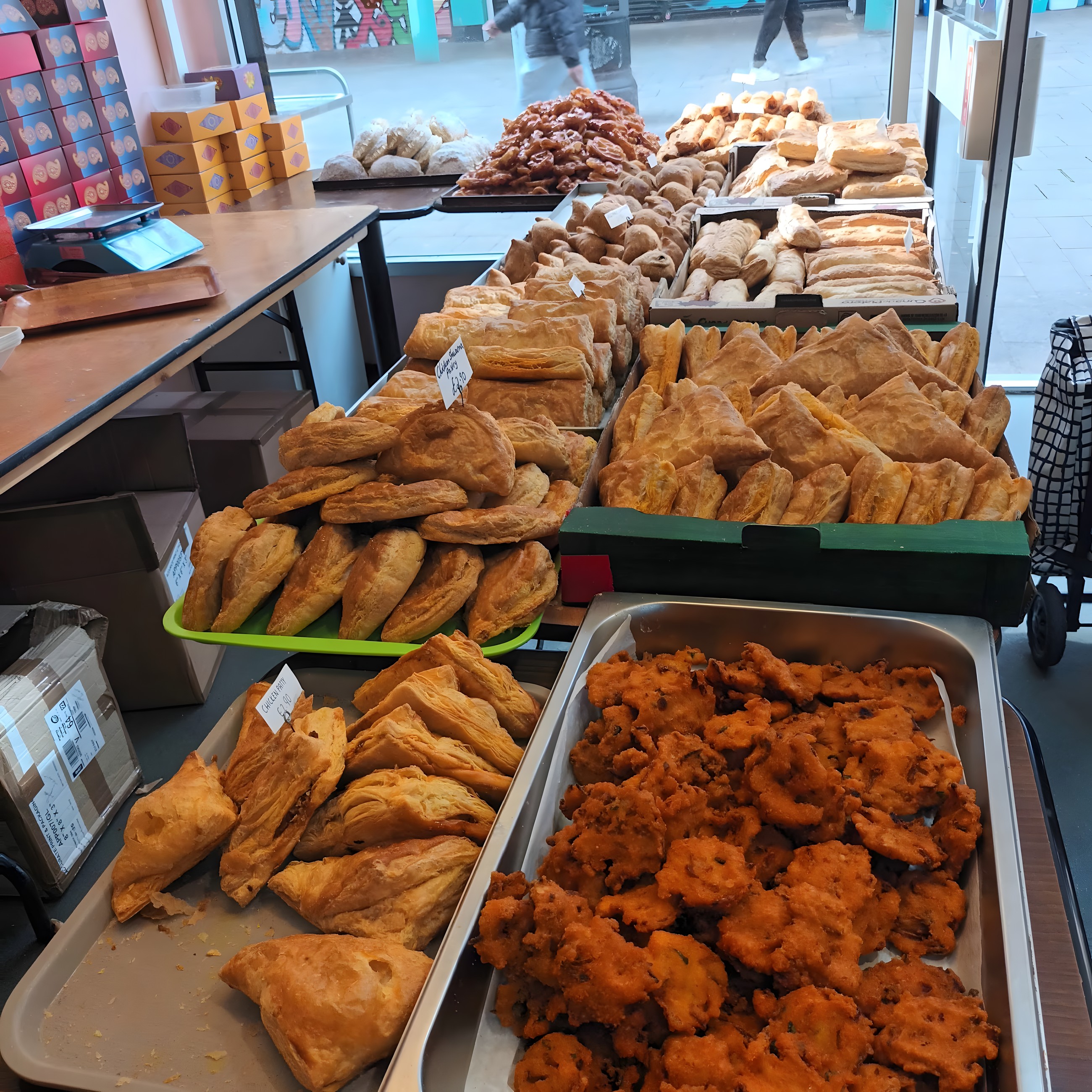 Counter of freshly made samosas, pakora and savoury pastries